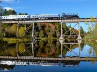 OEX 26, an extremely rare MLW M420TR (end cab version of M420W) heads east over the famous ex-CP Eastman trestle with the Orford Express train. Behind it are two RDC's, a dome car and an FL9 pushing at the rear. 