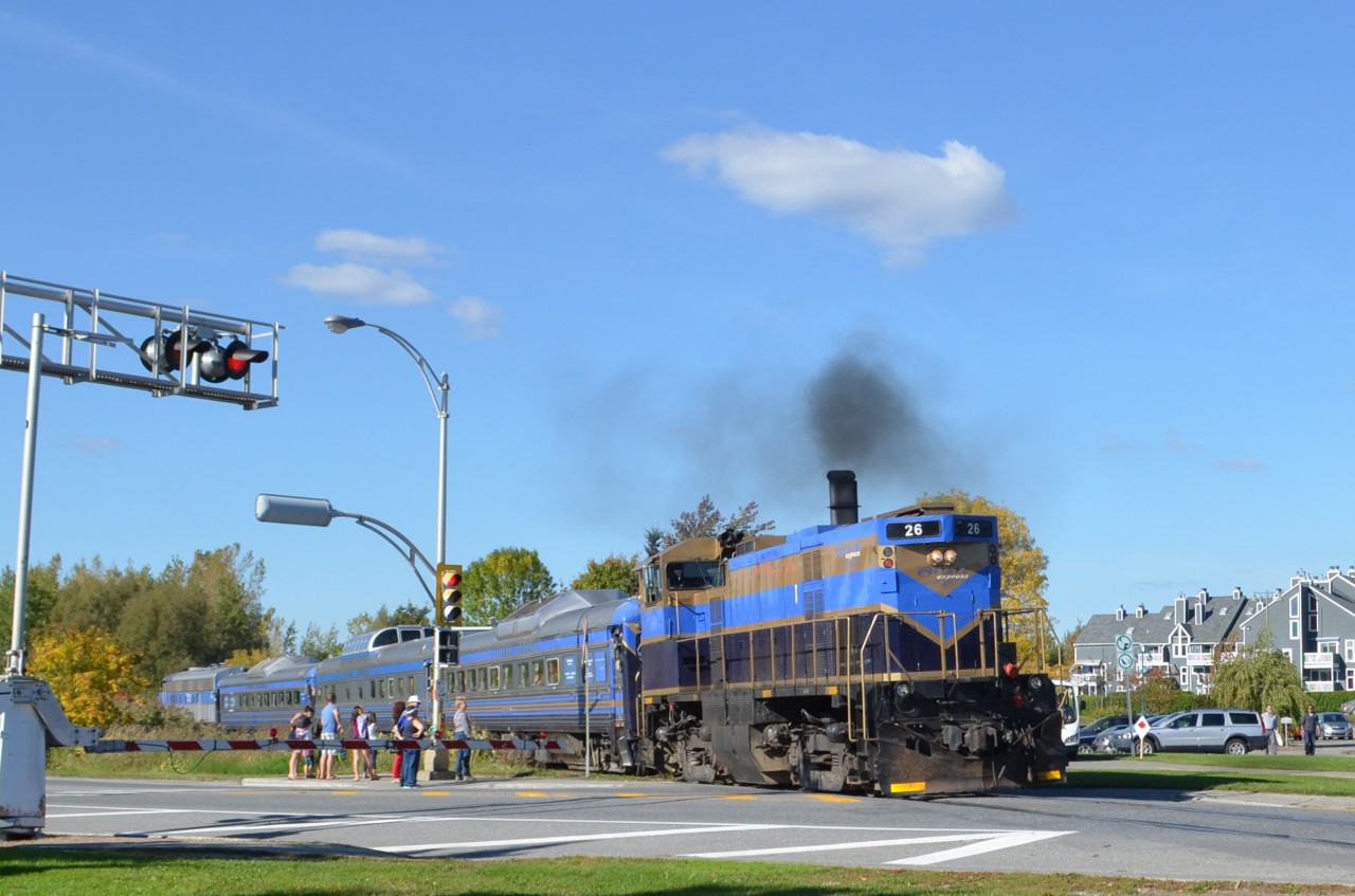 The Orford Express crosses busy rue principale in Magog; consist was OEX 26 (MLW M420TR), two RDC's sandwiching a dome car and FLNX 484 (EMD FL9).