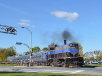 The Orford Express crosses busy rue principale in Magog; consist was OEX 26 (MLW M420TR), two RDC's sandwiching a dome car and FLNX 484 (EMD FL9). 