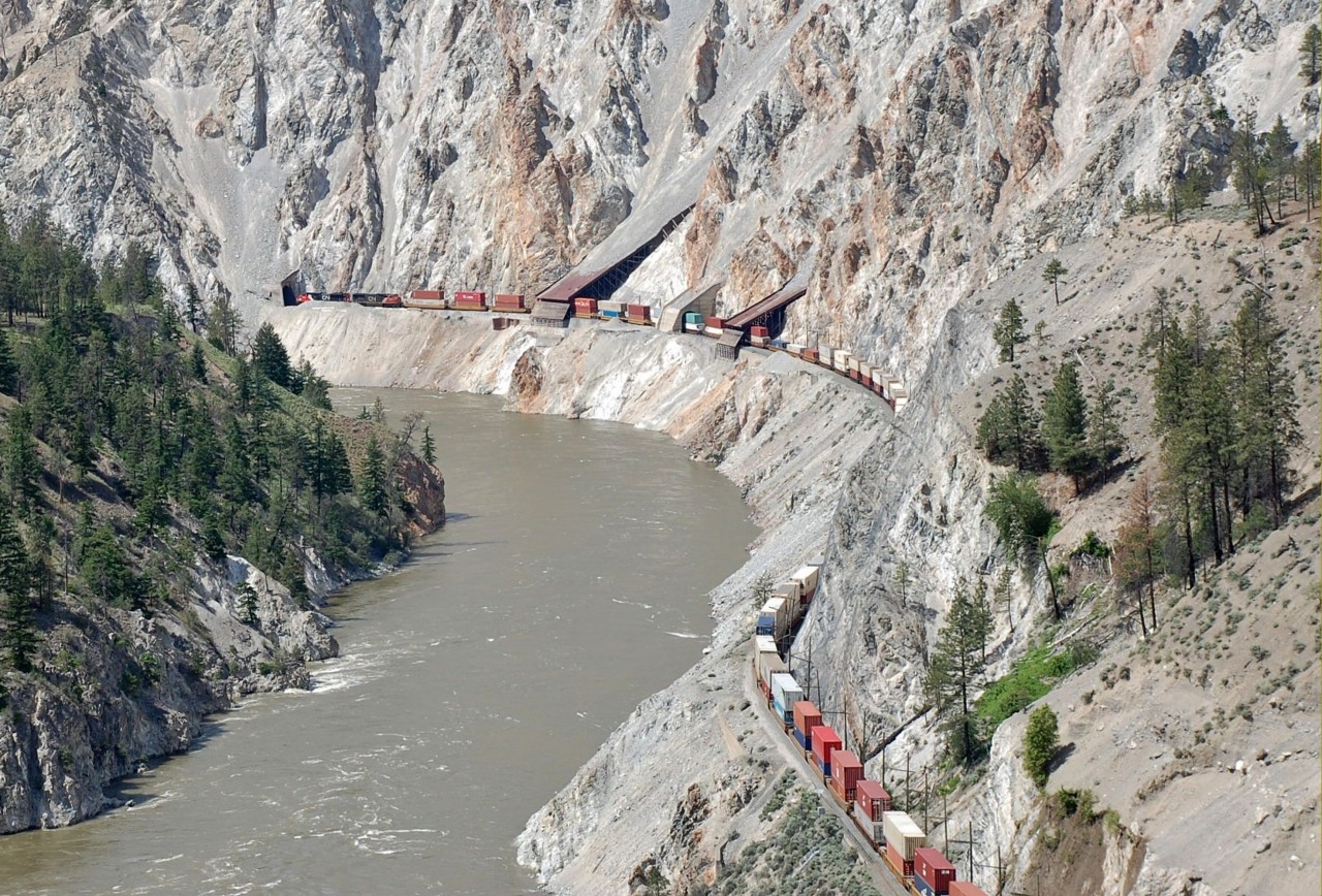 A CN Intermodal snakes alongside the Thompson River across from the Skihist Provincial Park as it approaches the town of Lytton.