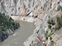 A CN Intermodal snakes alongside the Thompson River across from the Skihist Provincial Park as it approaches the town of Lytton.