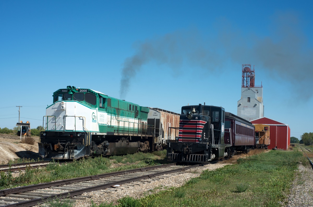 GWRS 2000 pulls loads from the elevator at Ogema past the Southern Prairie Railway shop track.