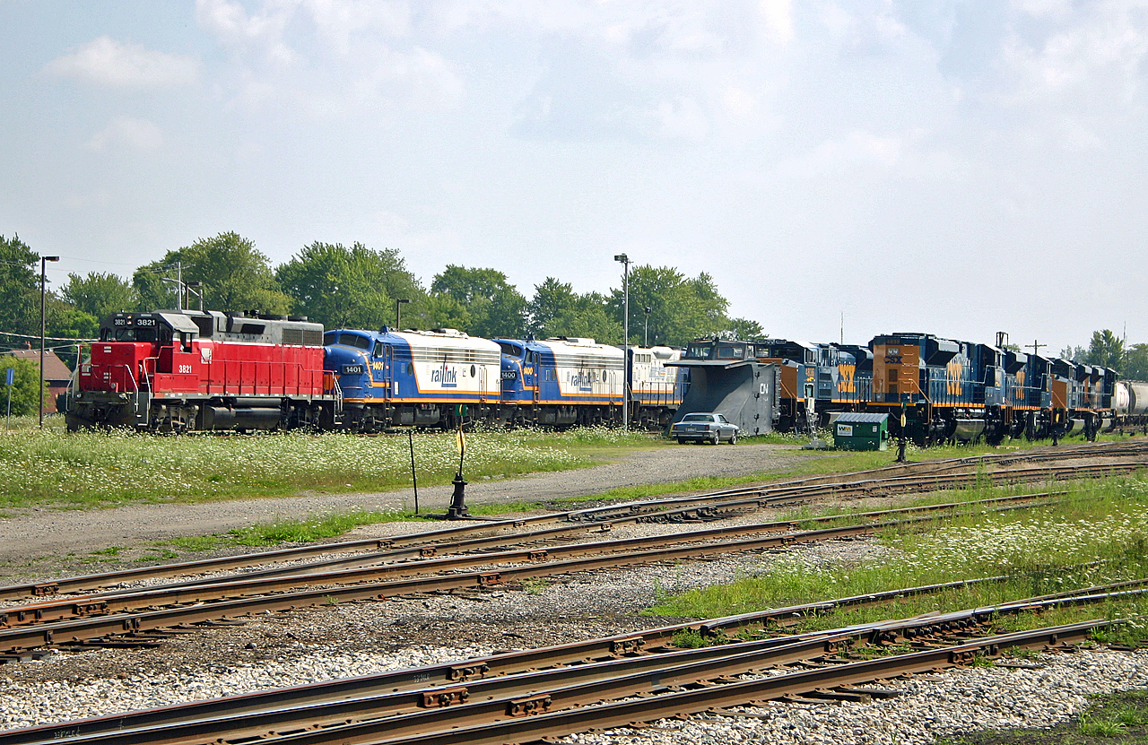 A look at the GEXR Stratford yard in 2004.  GEXR 581, the Stratford to Goderich turn builds it's train before heading towards Goderich with a nice assortment of power: GEXR 3821, RLK 1401, RLK 1400 and RLK 4001.  Sitting in the yard are 5 CSX SD70ACe's which EMD was testing on the GEXR.