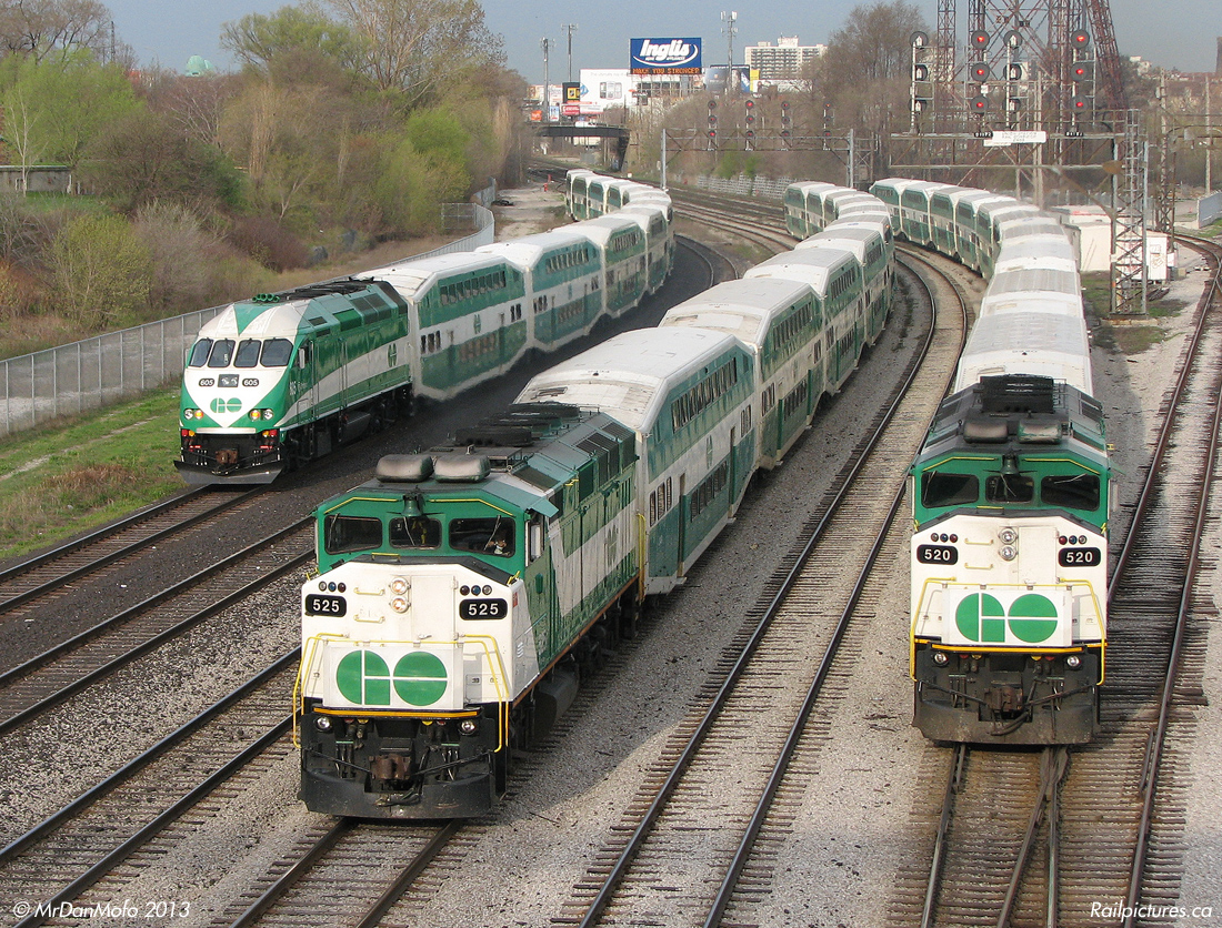 Everything's Gone Green.

GO F59PH 525 hauls inbound Lakeshore West train 906 eastbound to Union Station in between two not-in-service consists at Bathurst Street bridge, one with then-brand new MP40PH-3C 605 (equipment move 152 off the Milton line), and the other with GO's first and oldest F59PH, 520 (equipment move 206 off the Georgetown line). Both consits are heading west to Willowbrook after completing their morning runs and unloading their commuters downtown. The face of commuter railroading in Toronto for years, as time when on most of the earlier F59's including 520 and 525 have been retired and sold off, pushed out as 605's sisters were delivered and more of the New Order came online.