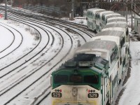 <b><u>Early Bird gets the Worm.</u></b> <br><br> A frigid early morning at Bathurst Street bridge finds GO 529, the only unit that kept its original numberboards, pushing an outbound train past Bathurst St. at 07:11 hrs. The neon glow of the famed Inglis sign lights up the background (later turned off at 8:00am), broadcasting inspirational messages on its LED display to traffic on the Gardiner Expressway. Today's message: "Children Have More - Need of Models - Than of Critics". <br><br> To shoot the morning rush, a few liberties were required. It usually went something line: rise by 4:00-4:30am (often on little sleep), a warm shower one was weary of leaving, brekkers, out the door by 5am to catch the 5:20am GO bus, to the 5:50am GO train, arriving at Union Station at 6:25am. Grab a muffin or Cinabon and walk the ~25 minutes (20 if you're really running) to Bathurst St. to shoot the morning rush from 7-9am. Then, go about whatever needed to be done in the city, albeit a little sleepy. If one was quick, they could shoot The Canadian leaving at ~9:05 at Bathurst, make it back to Union on foot with time to spare for the 9:30am train back to Bramalea, and be home before lunch (usually followed by a few hours' nap before the rest of the day).