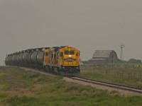 Great Sandhills Railway B23-7 #4253 and a sister are a few miles out of Leader headed for the gas plant at McNeil Alberta. The haze in the air is from forest fires buring in Alberta and British Columbia