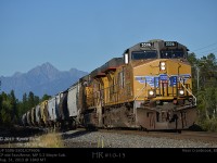With Fisher Peak rising above the heat, UP5506 and 5501 with rear DPU CP 9606 are about to crest the Fassiferne Hill on the Moyie Sub with loaded grain bound for U.S ports.