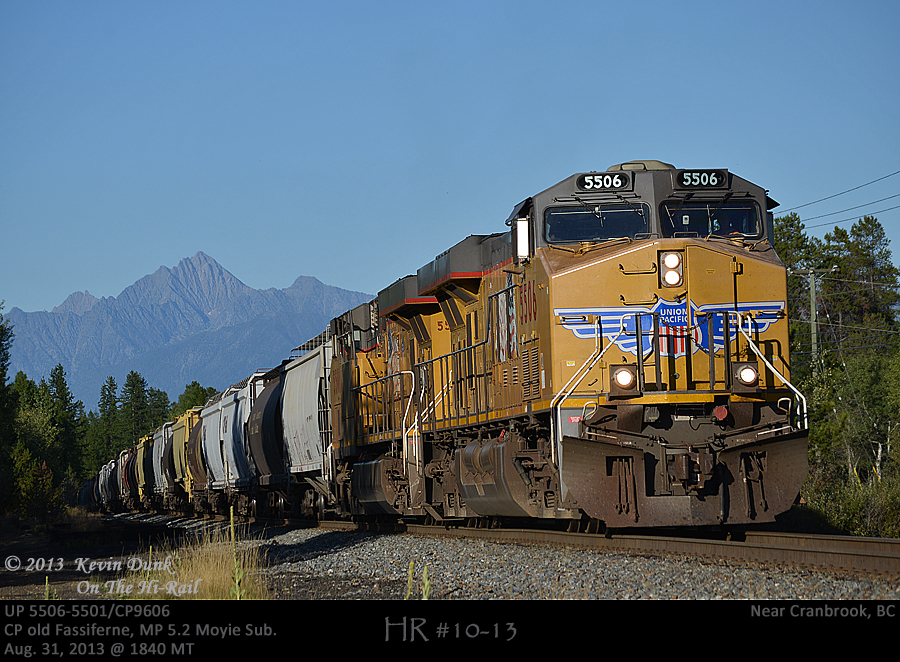 With Fisher Peak rising above the heat, UP5506 and 5501 with rear DPU CP 9606 are about to crest the Fassiferne Hill on the Moyie Sub with loaded grain bound for U.S ports.