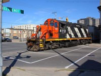 CN 4112 crosses over Colbourne Street in downtown Brantford.  They are running on the CN Burford Spur and are currently on Clarence Street on the Street Running portion of the Burford Spur. <br> Last week CN released a notice stating its intentions to discontinue its service on the Burford Spur.  If by November 21, 2013 nobody has expressed interest in the line, the line will be offered to the government and if no one shows interest in it, service will cease to exist by December 21, 2013.  <br> Hopefully this isn't my last time shooting 580 on the Burford Spur..