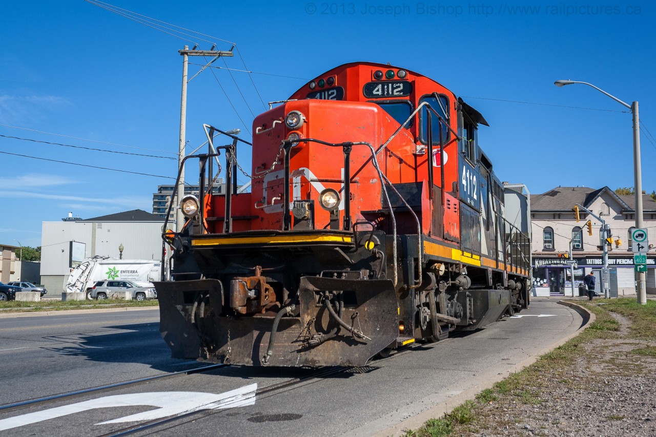 CN 4112 negotiates its way through downtown Brantford on the CN Burford Spur.  They are about to exit the street running portion of the spur and continue down to Ingenia.   Thanks to Ryan Gaynor with helping editing this image.
