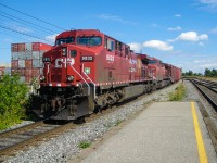 CP 9832 & CP 8563 head west past the platform of AMT's Lachine Station. To the left are stored containers in CP's Lachine Intermodal Yard. For more train photos, check out http://www.flickr.com/photos/mtlwestrailfan/