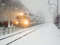 Cab car AMT 2000, a Bombardier bilevel car, is westbound and about to stop at Montreal West Station during a very snowy afternoon rush hour. Pushing at the other other end is AMT 1330 (GMD F59PHI). At the left, dozens of high school students wait to board this train, as there are a number of high schools nearby. For more train photos, check out http://www.flickr.com/photos/mtlwestrailfan/