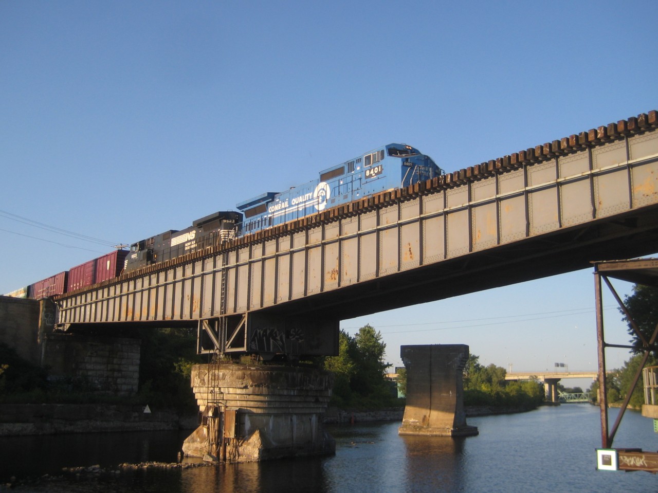 Big Blue over the Lachine Canal Long after Conrail had been divided up between CSX and Norfolk Southern, but before they repainted all their ex-Conrail engines, it was still possible to see Conrail painted engines in Montreal. Here we see NS 8401 leading a train southbound over CP's Rockfield bridge. NS 8401 is a Dash8-40CW which was built by GE as CR 6199 in 1993. Trailing unit is NS 9523.