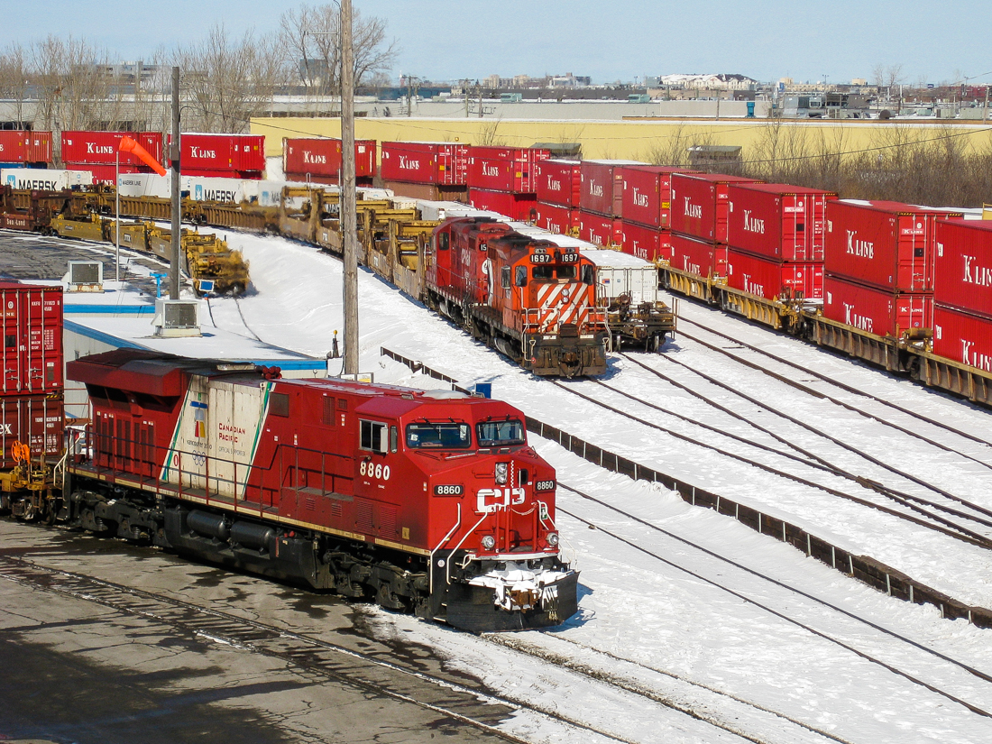 CP 8860 (freshly painted in the olympic paint scheme at the time) leads an intermodal train through the Lachine Yard, while a pair of GP9's idle nearby (CP 1697 and an unidentified 1500 series GP9). For more train photos, check out http://www.flickr.com/photos/mtlwestrailfan/