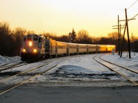 <b>The old AMT.</b> An eastbound train consisting of AMT 1313 (an ex-CN GP9), a generator car and 6 ex-GO Transit single level cars (dubbed 'GO Karts' by local railfans) passes through Montreal West at sunset during 2009. The GP9's and generator cars would be out of service by the end of 2009 and have since left the roster. The single level cars were replaced by new Bombardier multilevel cars in the summer of 2010 and have also left the roster. For more train photos, check out http://www.flickr.com/photos/mtlwestrailfan/