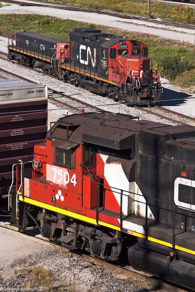 Workhorses converge in the same frame at MacMillan Yard. GP38 #7504 shoves a large cut of outbound cars into the Halton traffic bowl while GP9RM #7265 and it's faithful slug companion take a breather just shy of the secondary hump's southern yard ladder.