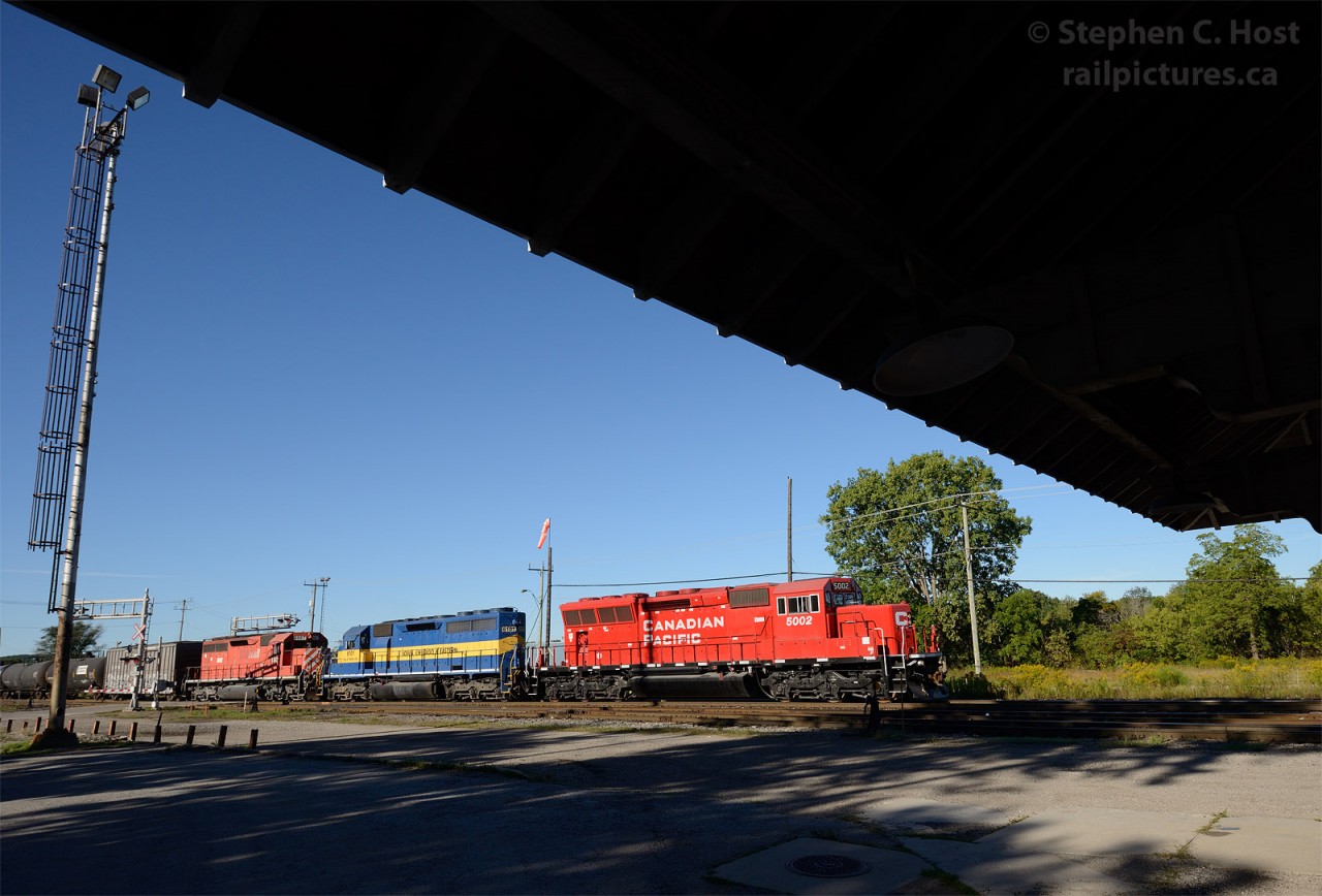 Train 640 rolls by Woodstock CP Station with a triplet of new and old EMD power - (photo taken at 20mm on 35mm digital)