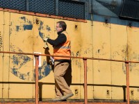 <b>A Scratch behind the ear..</b> is what the Chessie Cat would be getting as the Engineer is about to open an engine access panel. A very faded, but otherwise intact Chessie System logo is seen on OSRX 175, formerly CO 6193.