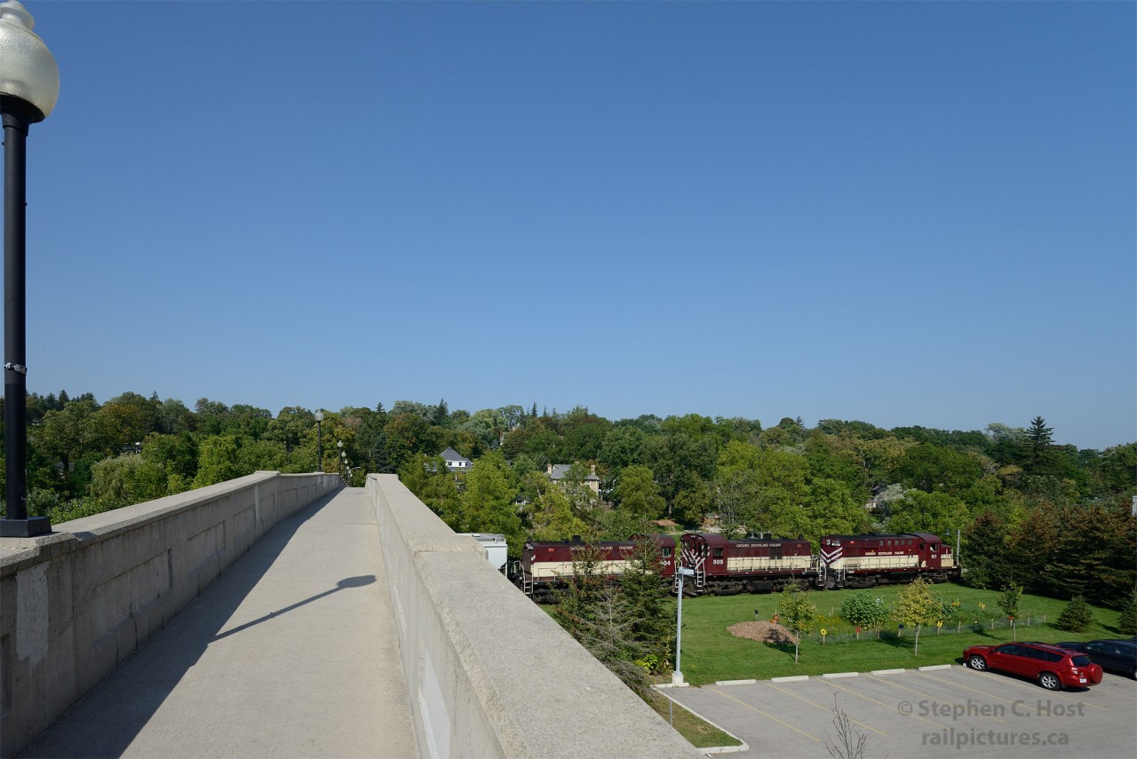 Built in 1914, the Heffernan St. pedestrian Bridge was constructed to avoid the then sprawling CPR Freight yard (and Freight shed tracks) in downtown Guelph, for pedestrians walking to their homes on the east side of the Speed River. In this scene, the Ontario Southland Railway is returning south after a long and hot muggy day of switching cars in North Guelph - with more work to do near lower yard in the south end before returning to Guelph Junction.