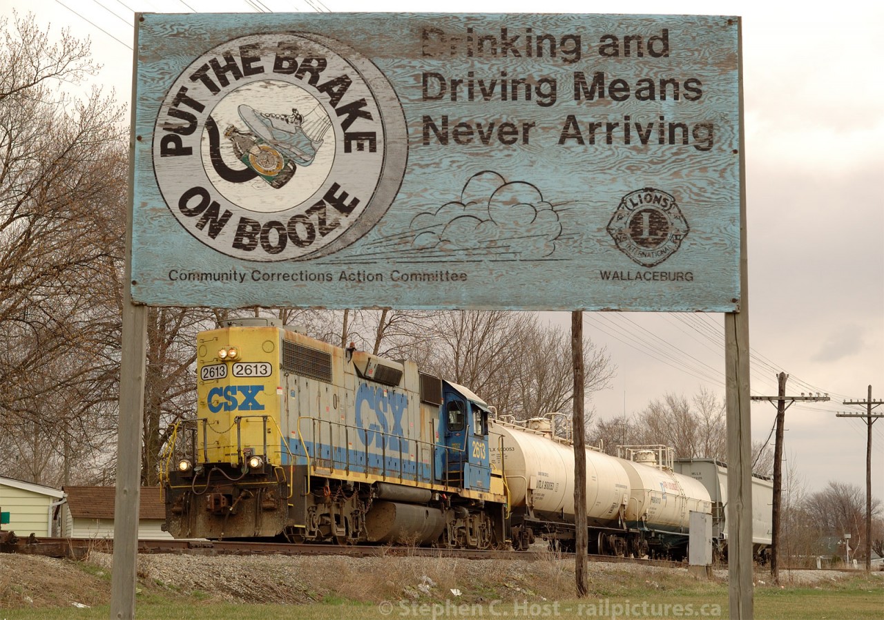 CSXT Train D924 (Sarnia, ON to Dresden Turn) with GP38-2 2613 is running long hood forward through Wallaceburg on the old C&O Canadian Division. With two cars for liquid air at Sombra 12 miles to the north and work recently completed at Tupperville (5 cars) and Wallaceburg (single car into the old Libbys glass plant) the long meandering day has a couple hours remaining for the crew. A friendly reminder to "put the brake on booze" as the sign says :)
