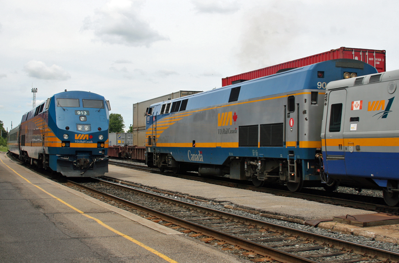 VIA 913 and train 42 sits outside the station at Smiths Falls, while VIA 45 with 901 rolls through town.