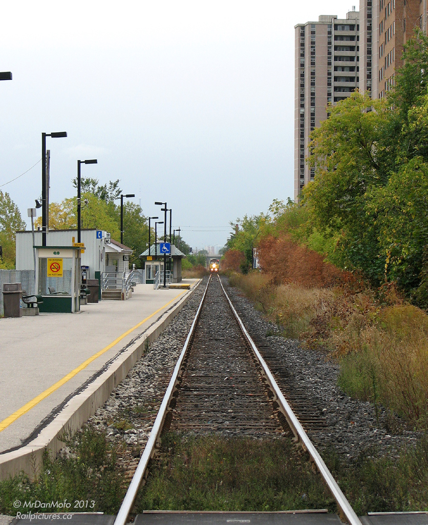 Motoring northbound in the late morning, VIA train 85 with F40PH-2 6427's faded yellow nose in the lead bears down on John Street crossing in the community of Weston. 15 minutes out of Toronto Union Station, 85 won't be stopping at the platforms of the GO train-only Weston Station pictured.

Today, the site where this station is is just a big hole in the ground: all the structures have since been demolished (including the former CN waiting room building dating to pre-GO days), a new station has been built to the south of Lawrence Ave., the track has been temporary shifted to the CP line nearby, and a large trench occupies this site as Metrolinx continues the process of lowering the rail corridor through Weston, in preparation for the Pearson Air Rail link and more frequent Kitchener (Georgetown) line GO service through the community.