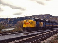 VIA train 12 makes a station stop at Matapedia on a dreary fall day, before getting under way to the east coast behind a classic VIA lashup