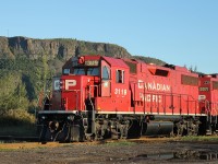 In the lee of Mount McKay and the evening sun, the afternoon roust is travelling from CP’s Westfort yard along the Farm Lead to service several industries in this corner of Thunder Bay. The engineman had previously stopped the units, a pair of GP38-2’s – 3071 and 3119 – clear of the ‘other’ CN diamond in Thunder Bay and contacted the CN RTC in Edmonton for permission to cross.  Upon receiving a clear aspect from the dwarf signal protecting the interlocking, CP 3119 is now on top of the diamond crossing as the units proceed towards Resolute Forest Products.