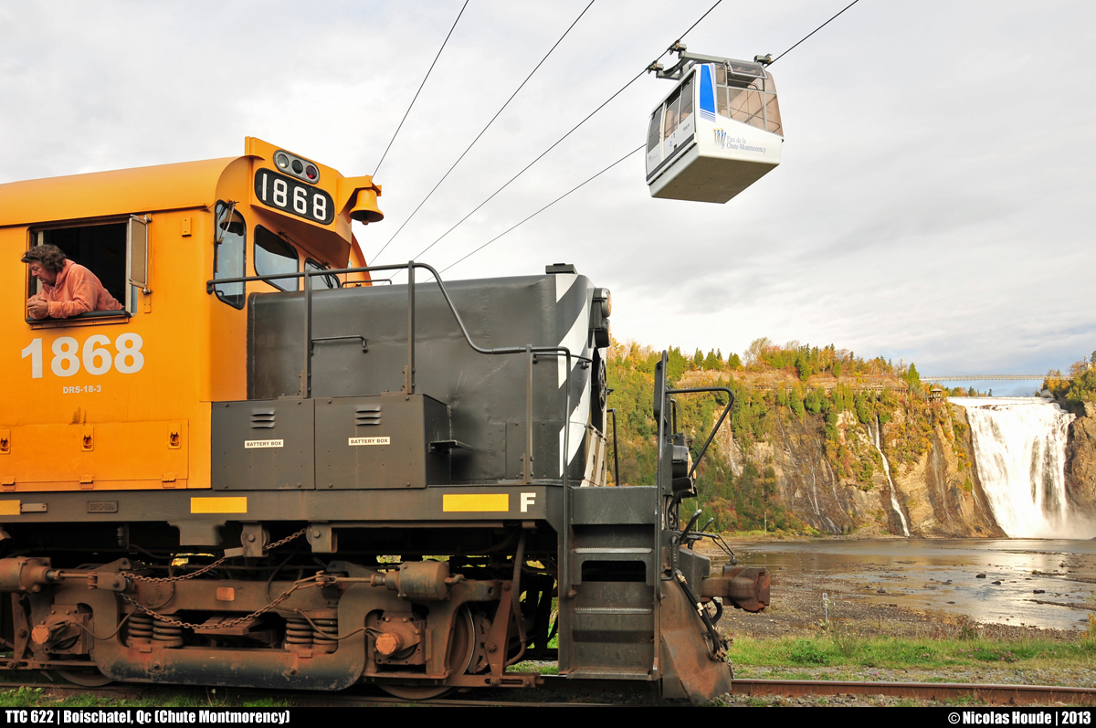 Under the cable car, TTC #622 is preparing for the departure for another day on the Charlevoix Subdivision (ex-CN Murray Bay Subdivision) in front of the Montmorency Falls.