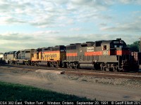 CSXT GP39-2 #382, an ex-Guildford, exx-D&H unit, leads a colorful quartet of power into Van De Water Yard in Windsor, Ontario on September 20, 1991.  With Guilford, CSX, Chessie and D&H Lightning stripes represented all on one train, it made for a 'must shoot' scenario....  :-)