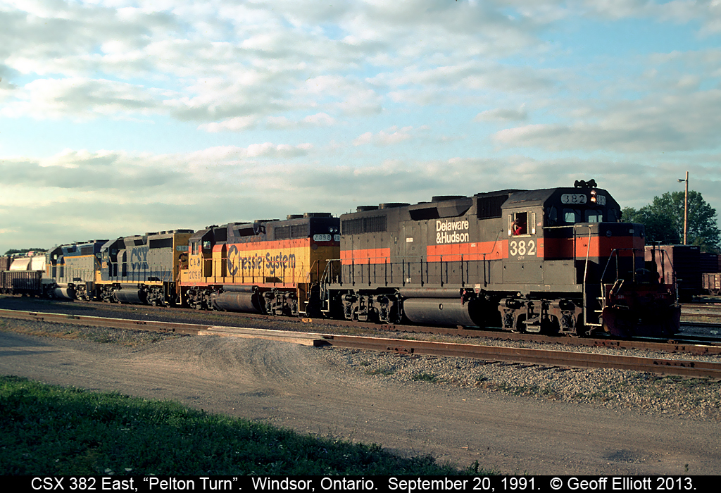 CSXT GP39-2 #382, an ex-Guildford, exx-D&H unit, leads a colorful quartet of power into Van De Water Yard in Windsor, Ontario on September 20, 1991.  With Guilford, CSX, Chessie and D&H Lightning stripes represented all on one train, it made for a 'must shoot' scenario....  :-)