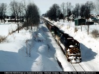 Cape Breton & Central Nova Scotia #2035 rolls downgrade into Mitchell, Ontario as the Goderich & Exeter train heads east to Stratford.  Problems would soon arise for 2035 as it stalled near Stratford.  As a result of the cold temperatures the air started blew on the unit rendering it, along with the already dead GEXR 180, useless.  The ex-BN GP40 would be the sole power to bring the train into Stratford as they had to quadruple the train into town.  Sadly 2035 would never be repaired and this would be the last time it was seen running.