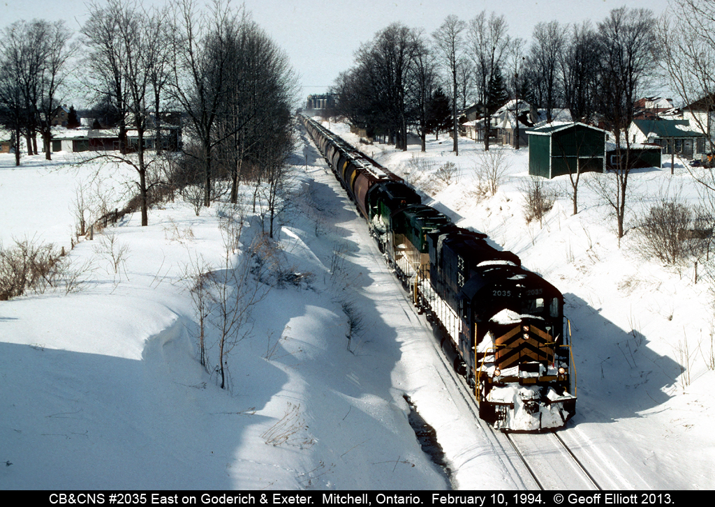 Cape Breton & Central Nova Scotia #2035 rolls downgrade into Mitchell, Ontario as the Goderich & Exeter train heads east to Stratford.  Problems would soon arise for 2035 as it stalled near Stratford.  As a result of the cold temperatures the air started blew on the unit rendering it, along with the already dead GEXR 180, useless.  The ex-BN GP40 would be the sole power to bring the train into Stratford as they had to quadruple the train into town.  Sadly 2035 would never be repaired and this would be the last time it was seen running.