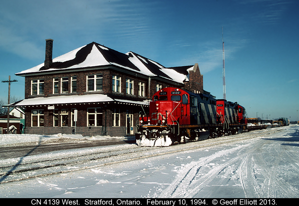 On a day where we saw the wind chill hit -35F, a pair of rebuilt geeps lead the local past the old CN Stratford station.  It's February 10, 1994 and we're waiting on the GEXR train from Goderich, with CB&CNS C630 #2035 on the point, to arrive at the junction to yard it's train.
