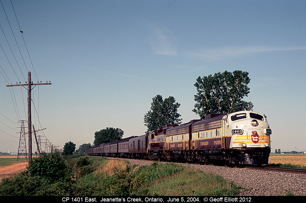 CP FP9A #1401 leads the eastbound Business Train through Jeanette's Creek, Ontario on June 5, 2004.  This was the first hit of the day as the chase ensued after.  We followed 1401 to London, then Woodstock, Guelph Jct., Hamilton, and finished the day up on the OSR.  Quite a day, and a great chase.