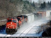 CN 2688 west kicks up snow as it cruzes around the bend nearing Denfield Road overpass just west of London, Ontario back on December 27th, 2004.
