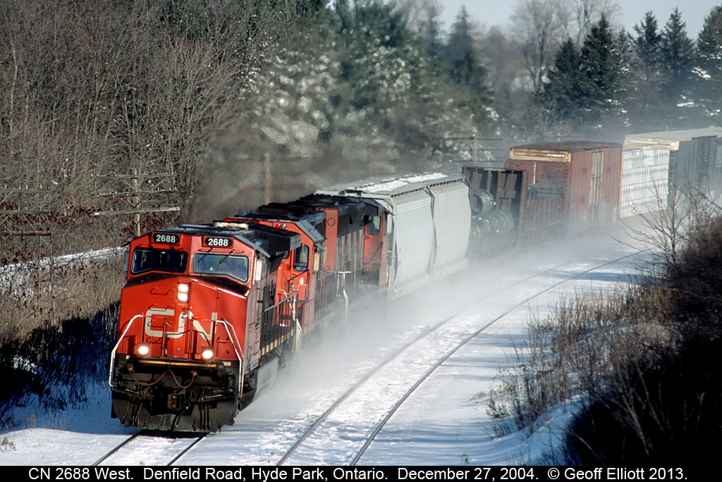 CN 2688 west kicks up snow as it cruzes around the bend nearing Denfield Road overpass just west of London, Ontario back on December 27th, 2004.