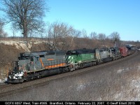 This is CN?? Yupp..... CN train #385 with GCFX 6057, BNSF 6785, NREX (ex-QNS&L) 263, and IC 6050 head westbound nearing CP Massey on CN's Dundas subdivision on a clear, but cold, February day.  I lucked out as I was driving from Toronto to Windsor and saw the train from the 403 climbing the hill in Dundas.  Had plenty of time to get ahead of the train, but sadly had to revert to digital as I had NO FILM in my camera when I got in position!!!  Still was lucky enough to get a shot off though.