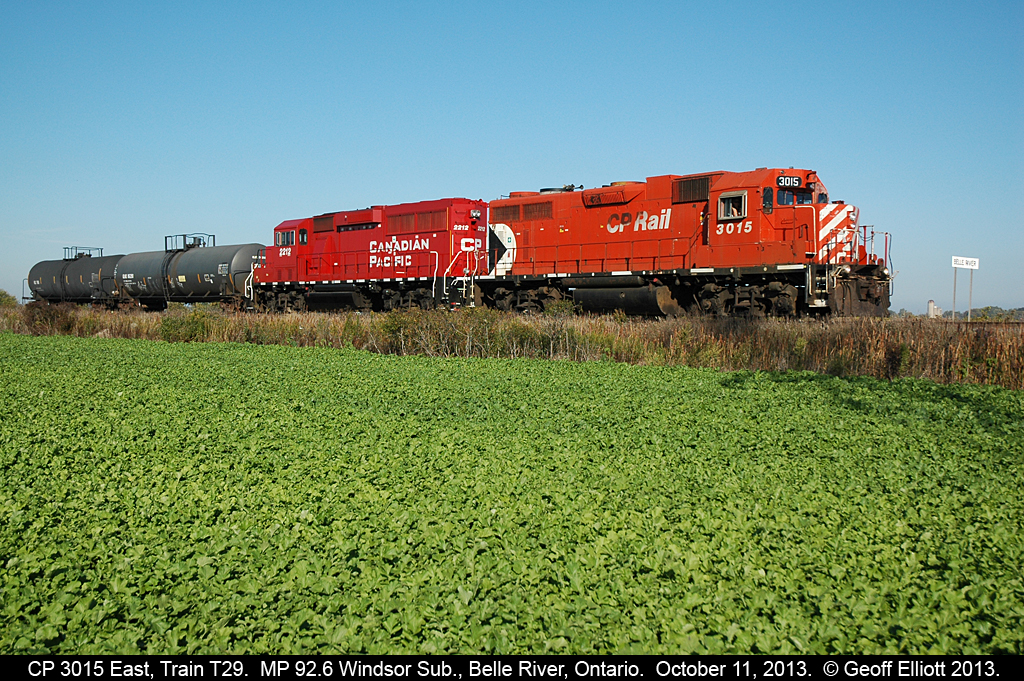 CP 3015 and 2212 have a pretty good handle on the 2 car T29 "Chatham Wayfreight" today as they pass the eastern "Belle River" mile board on their way to Chatham to perform their daily switching duties.