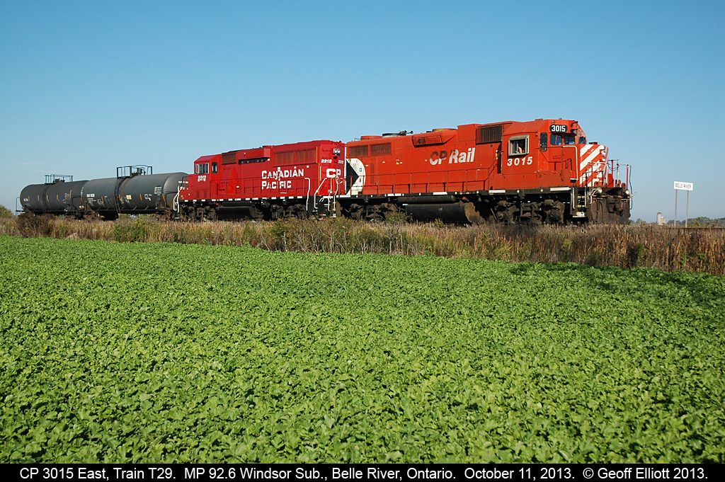 CP 3015 and 2212 have a pretty good handle on the 2 car T29 "Chatham Wayfreight" today as they pass the eastern "Belle River" mile board on their way to Chatham to perform their daily switching duties.