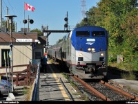 As the canadian flag waves, Amtrak #694 makes a little stop to Saint-Lambert station to pick up 2 passengers. In the background, you can see a part of the Victoria bridge.
