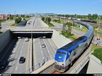 By a gorgeous morning, AMTRAK #694/68 (Montreal/New-York) cross the bridge over the highway 116 at Longueuil, QC. You can see the Montreal downtown in background, and the CN Southwark yard, in the right of the picture.