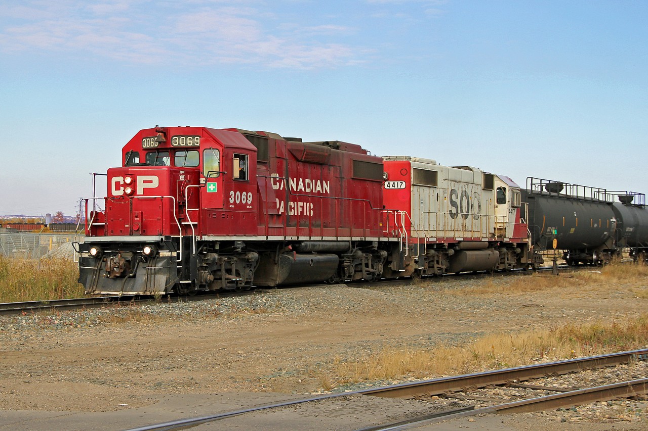 SD38-2's CP 3069 and SOO 4417 pick up tank cars at Clover Bar industrial sidings.