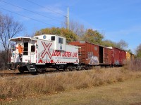 BNSF's daily interchange run to CP's yard returns to the depot along CP's La Riviere Sub. The caboose is used for all back up moves.