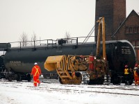 Crews from Hulcher's and CN work to rerail a few tankers that have been put on the ground by CN 398 the previous evening
