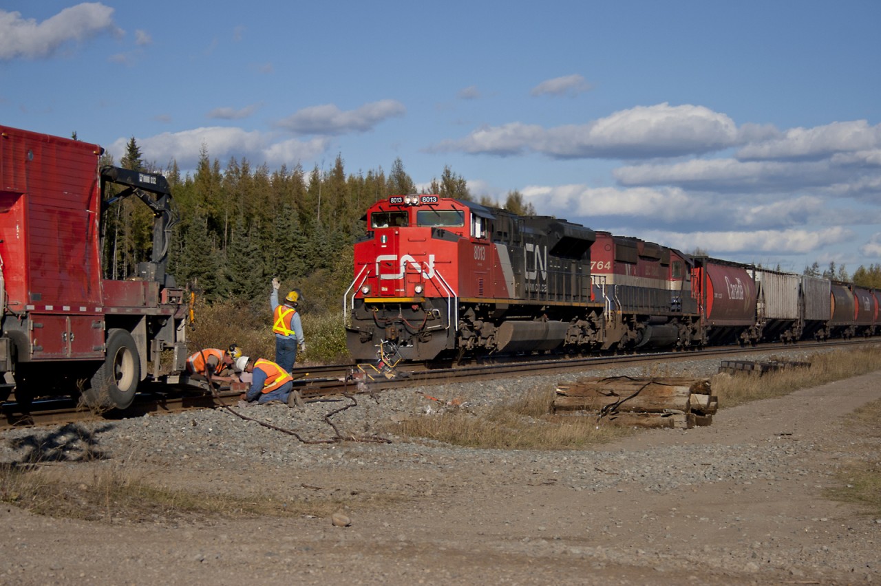 Westbound train 835 passes a crew repairing a rail joint west of Edson Alberta