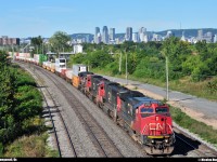 After leaving the island of Montreal, who can be seen in background, an ex-ATSF/BNSF (#800) unit leads the CN ''president train'' (CN 120) at Longueuil, QC.