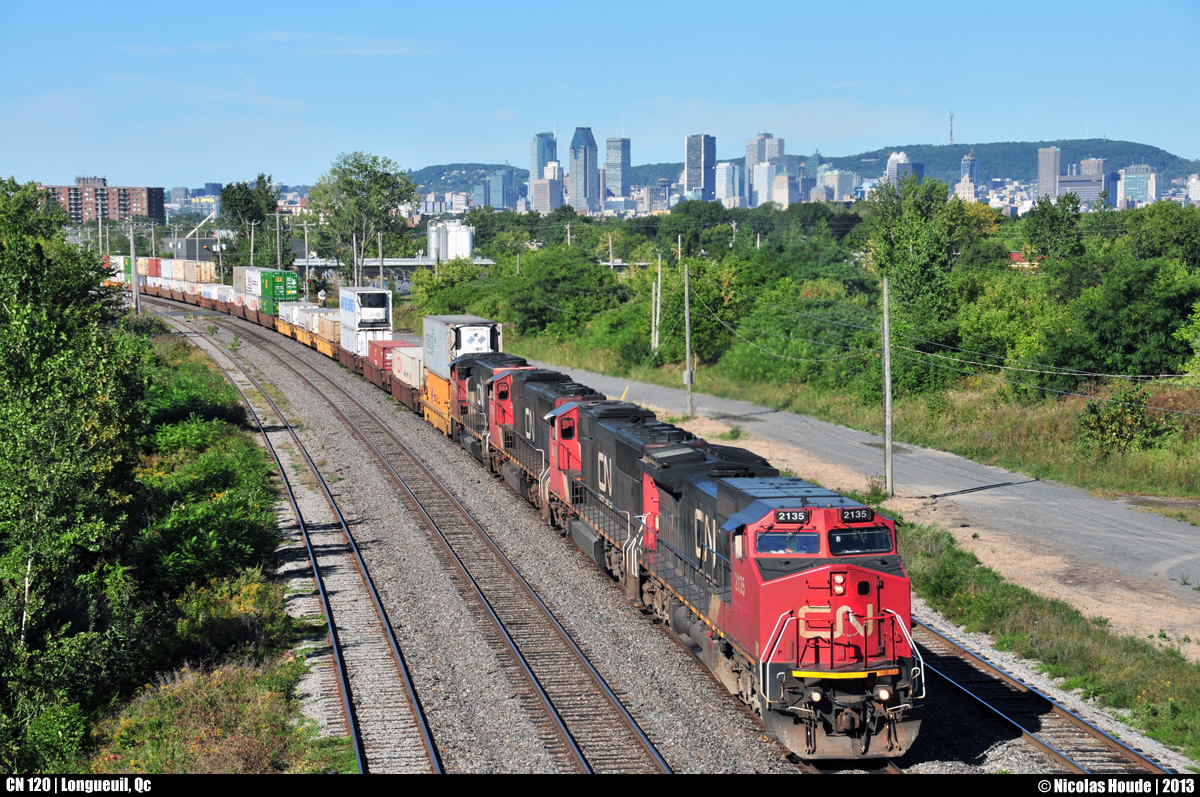 After leaving the island of Montreal, who can be seen in background, an ex-ATSF/BNSF (#800) unit leads the CN ''president train'' (CN 120) at Longueuil, QC.
