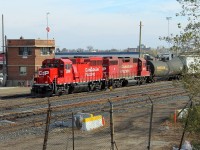 One of CP's new GP20C-ECOs and a GP38-2 lead a local out of the yard past the old tower at Rugby Junction.