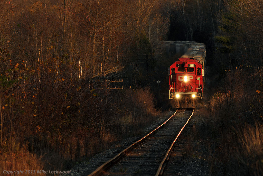 The Kawartha Lakes Railway road freight is a few miles from the crossing of the Trent Canal in Peterborogh on it's slow westward trek to Toronto. 1744hrs.